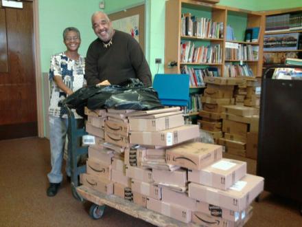 Mr. Wallace Sapp (right) helping to unload donated books during the Manchester Miracle.